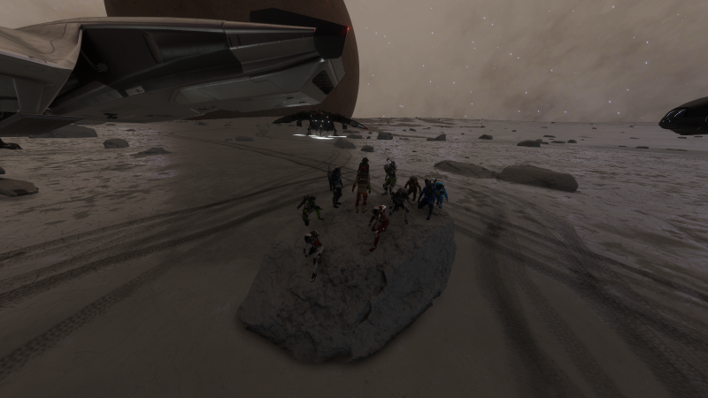 "Elite Dangerous pilots gathered on a boulder"